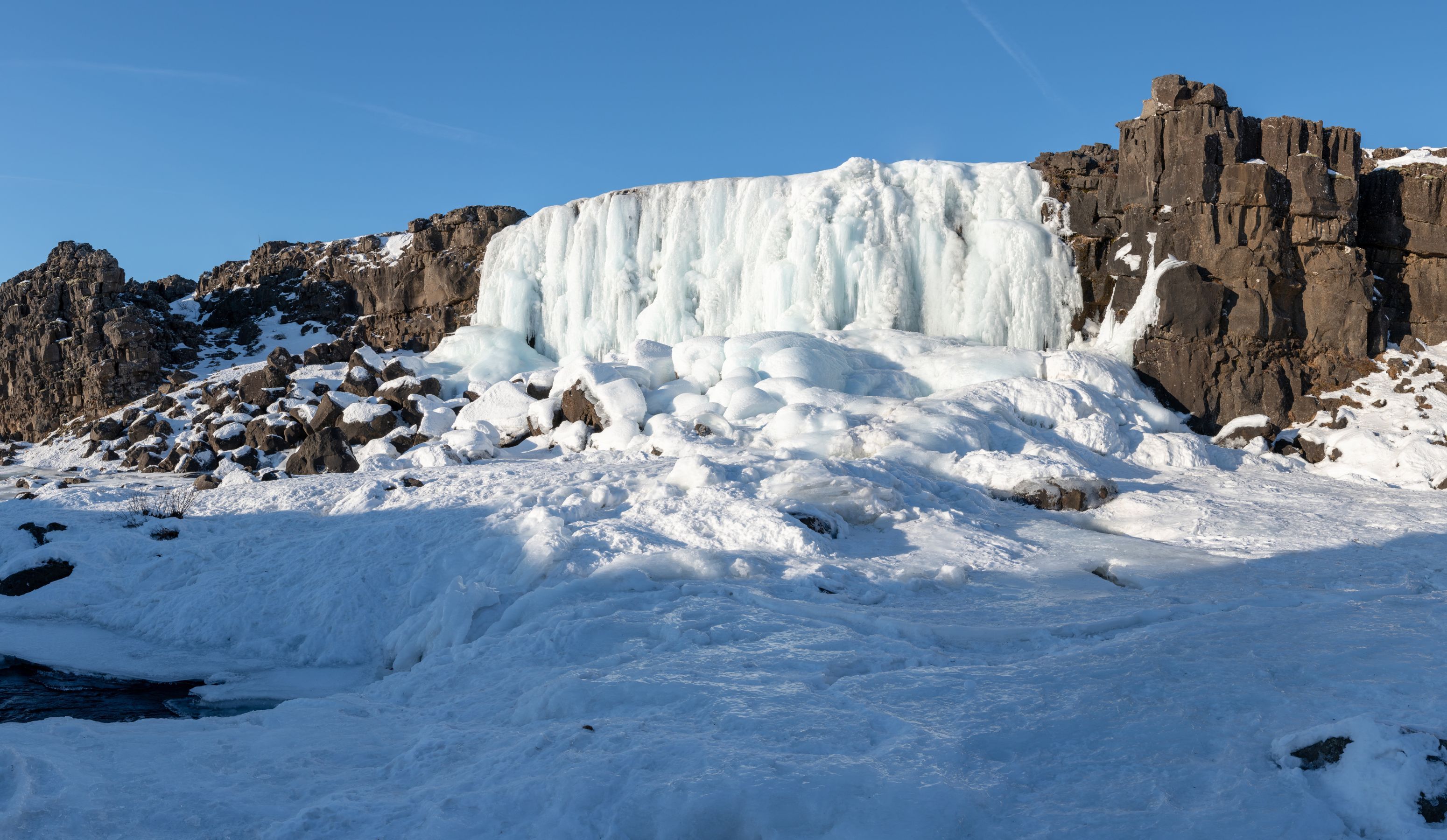 frozen waterfall in thingvellir national park.jpg